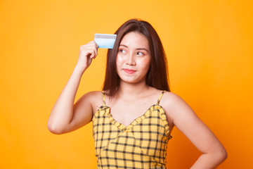 Young Asian woman think with a blank card.