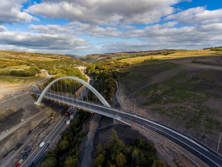 Aerial drone view of a large new bridge construction and major roadworks in Wales