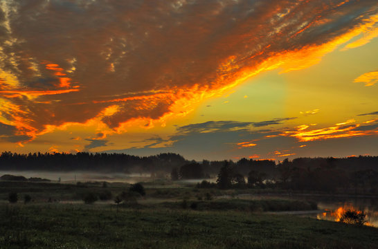 Fototapeta Red sunrise over the meadows