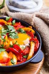 Shakshuka, fried eggs cooked in tomatoes and bell peppers sauce