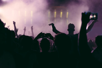 Crowd at a concert with hands up