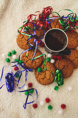 New Year and Christmas. Serpentine and garlands. Ginger and oatmeal cookies. New Year sweets. White background. Hot coffe in dark cup.