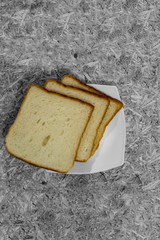 Bread pieces and slices in white plate