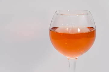 Glass of rose wine on white background