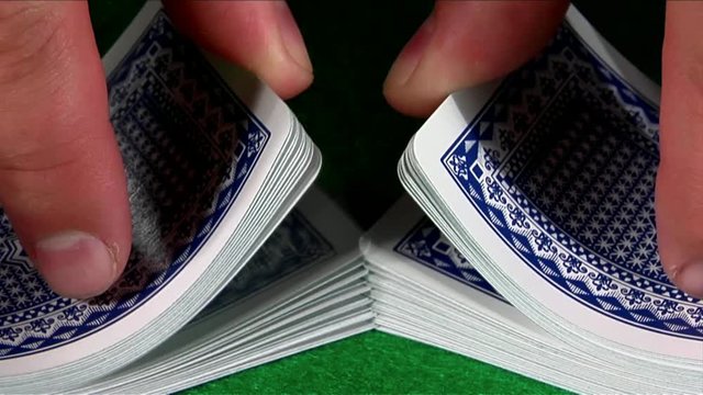 Loop of A deck of cards is shuffled in slow motion.