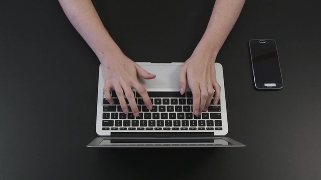 Loop of Top view of laptop and cellphone