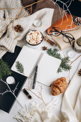 Winter Flat Lay . Hot chocolate or cocoa with marshmallow , cookies, notebook and tartan textured sweater on with  on white background.
