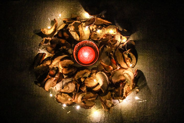 Night Helloween composition with dried apple and  candles.Warm and cold light.Garland.Autumn comfort.