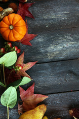 Autumn nature concept. Fall fruit and vegetables on wood. Thanksgiving dinner. Pears and pumpkin with sunflowers and apples.