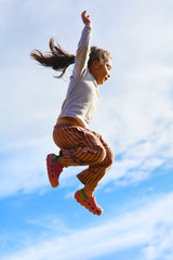 Excited native american girl jumping high.