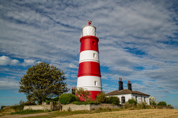 Fototapeta na wymiar Happisburgh lighthouse situtated in Norfolk in beautiful autumnal sunshine