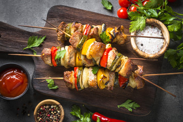 Grilled shish kebab with vegetables  on black.