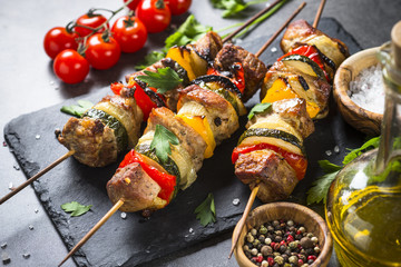 Grilled shish kebab with vegetables  on black.