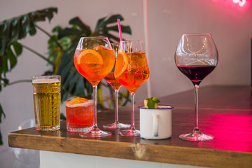 Several different smoothies in glasses of different shapes on the bar counter in the restaurant