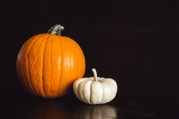 Orange and White Pumpkins on Brown Table