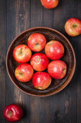 Red apples on a dark rustic background