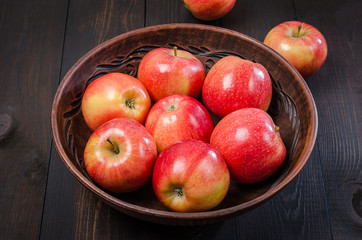 Red apples on a dark rustic background