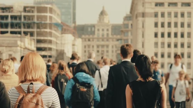 Anonymous crowd of people walking in London. Business people crossing the London Bridge. 120fps
