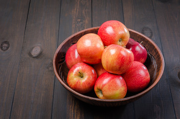 Red apples on a dark rustic background