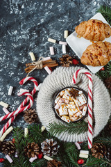 Winter hot drink. Chocolate or cocoa with marshmallow, cookies, candy on dark background . Flat Lay.