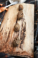 Autumn atmospheric composition of the home layout.Box from the vines, bumps, candles, cup of tea, autumn decor, wooden board and textiles.