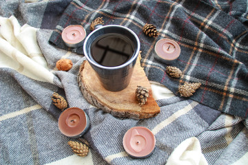 Autumn atmospheric composition of the home layout.Box from the vines, bumps, candles, cup of tea, autumn decor, wooden board and textiles.