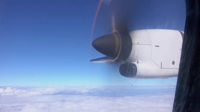 Loop of CLOSE UP: Small plane propeller spinning on airplane flight