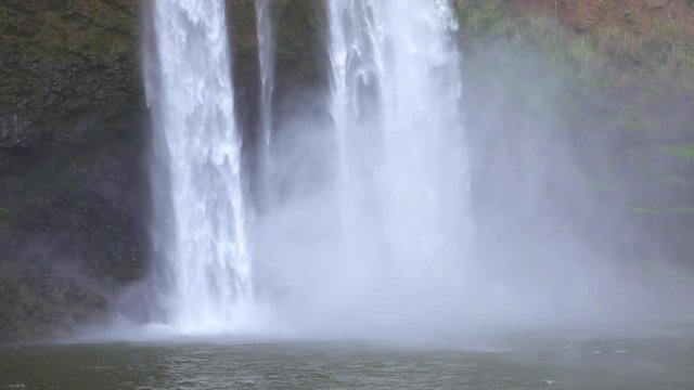 Loop of SLOW MOTION CLOSE UP: Whitewater waterfall falling heavily into the lake
