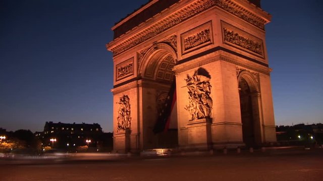 Loop of arc de triomph with abstract time-lapse of cars moving