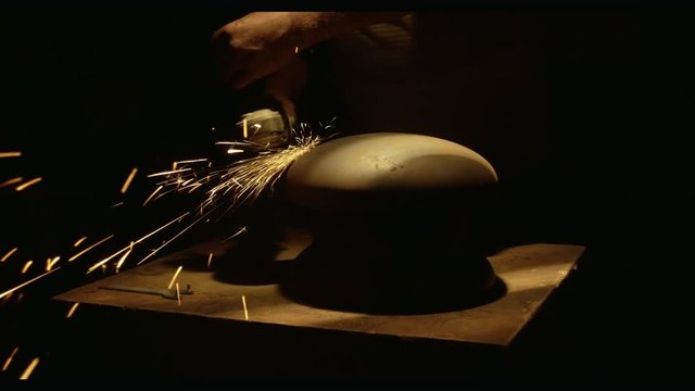 Master Grinds The Metal Workpiece