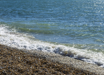 Waves From The Sea On A Stony Beach