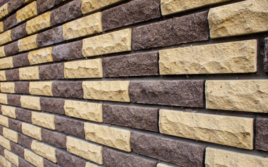 View at an angle on a wall of colored bricks close-up with blur for use as background