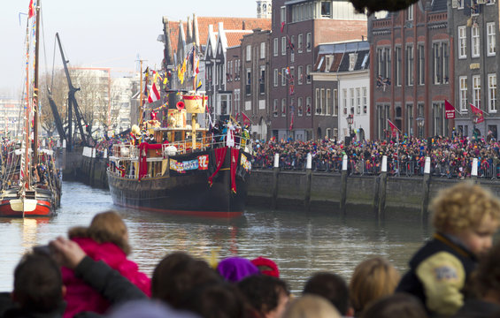 Ship of Saint Nicolas entering  the harbour of historical Dordrecht while the children wait in excited anticipation