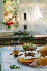 Bundt cake with saffron and rum covered with white glaze on rustic background with autumn decorations