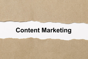 Fototapeta na wymiar Content Marketing text on paper. Word Content Marketing on torn paper. Concept Image.