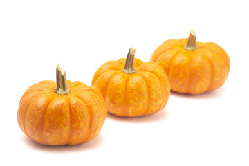 Small Decorative Pumpkins on a White Background