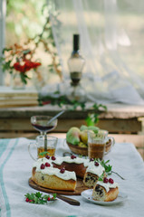 Bundt cake with cinnamon covered with white glaze on rustic background with autumn decorations