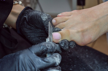 .The master makes a hardware pedicure in the studio