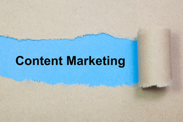 Content Marketing text on paper. Word Content Marketing on torn paper. Concept Image.