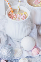 Cup of cacao with marshmallow, meringues and different Christmas decorations