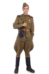 A soldier in military uniform of soviet army stay and hold submachine gun with one hand in pocket
