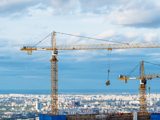 Fototapeta premium cranes on construction site of high-rise building