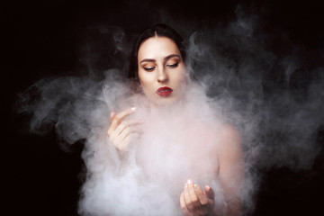 Attractive young girl and white smoke.