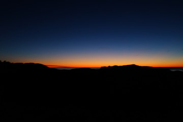 Sun rises over hills