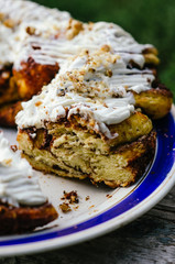 Cinnamon sweet bun close-up on a plate. Macro.