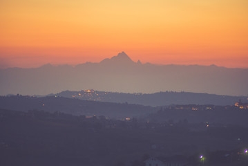 Langhe and Monferrato vineyards at sunset and Monviso in the background. Piedmont, italy
