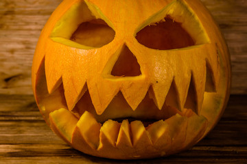 Spooky halloween pumpkin on a wooden table