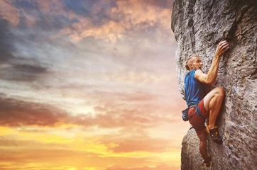 Foto auf Alu-Dibond rock climber climbing the challenging route on the limestone wall © vitaliymateha