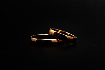 Wedding rings on a black background close up