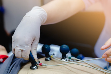Nurse measuring patients blood pressure electrocardiography